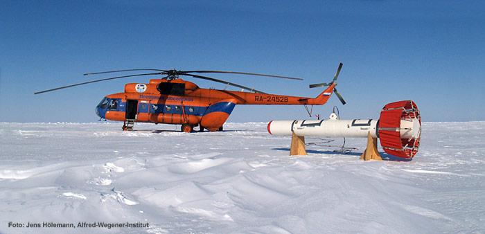 Der EM-Bird der Meereisgruppe des Alfred-Wegener-Institutes vor einem MI-8 Helikopter auf russischem Festeis. Der EM-Bird ist ein Sensor zur Bestimmung der Dicke des Meereises mit Helikoptern und Flugzeugen. Basierend auf dem aerogeophysikalischen elektromagnetischen (EM) Induktionsverfahren, wird die Dicke des Meereises bestimmt durch die Untersuchung der elektrischen Leitfähigkeit des Untergrundes.